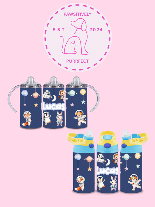 Set of children's cups with space-themed designs on a pink background, featuring the brand 'PAWSITIVELY PURRFECT'.