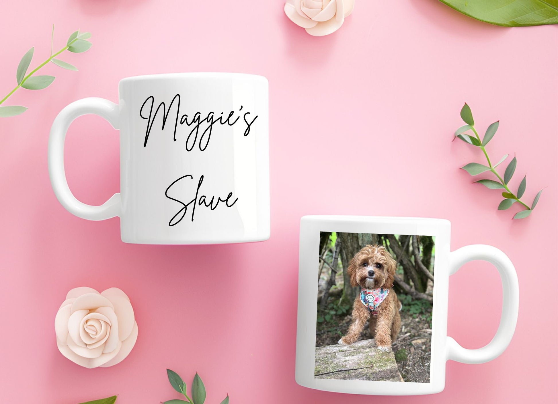 Two mugs on a pink background with one featuring Maggies Slave text and the other with a dog photo.