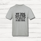 Gray t-shirt with black text on a wooden surface