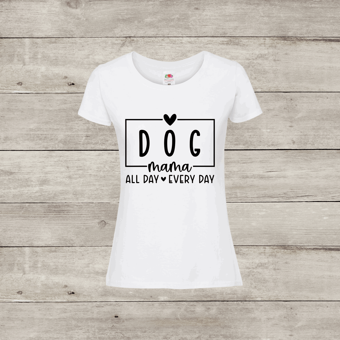White t-shirt with 'DOG mama ALL DAY EVERY DAY' text on a wooden surface