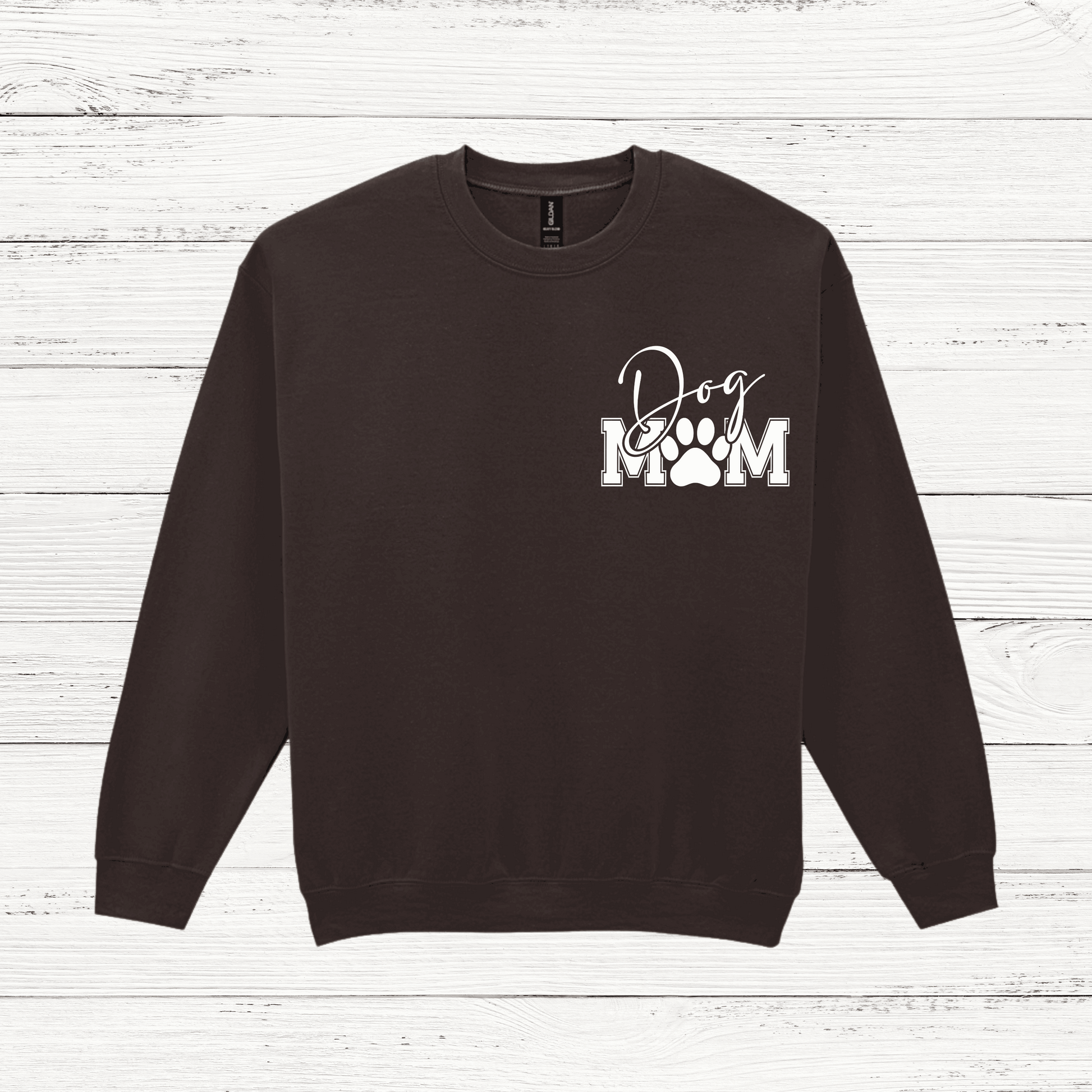 Black sweatshirt with 'Dog Mom' text on a wooden surface