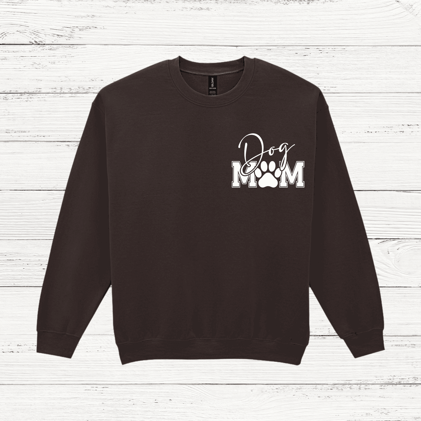 Black sweatshirt with 'Dog Mom' text on a wooden surface
