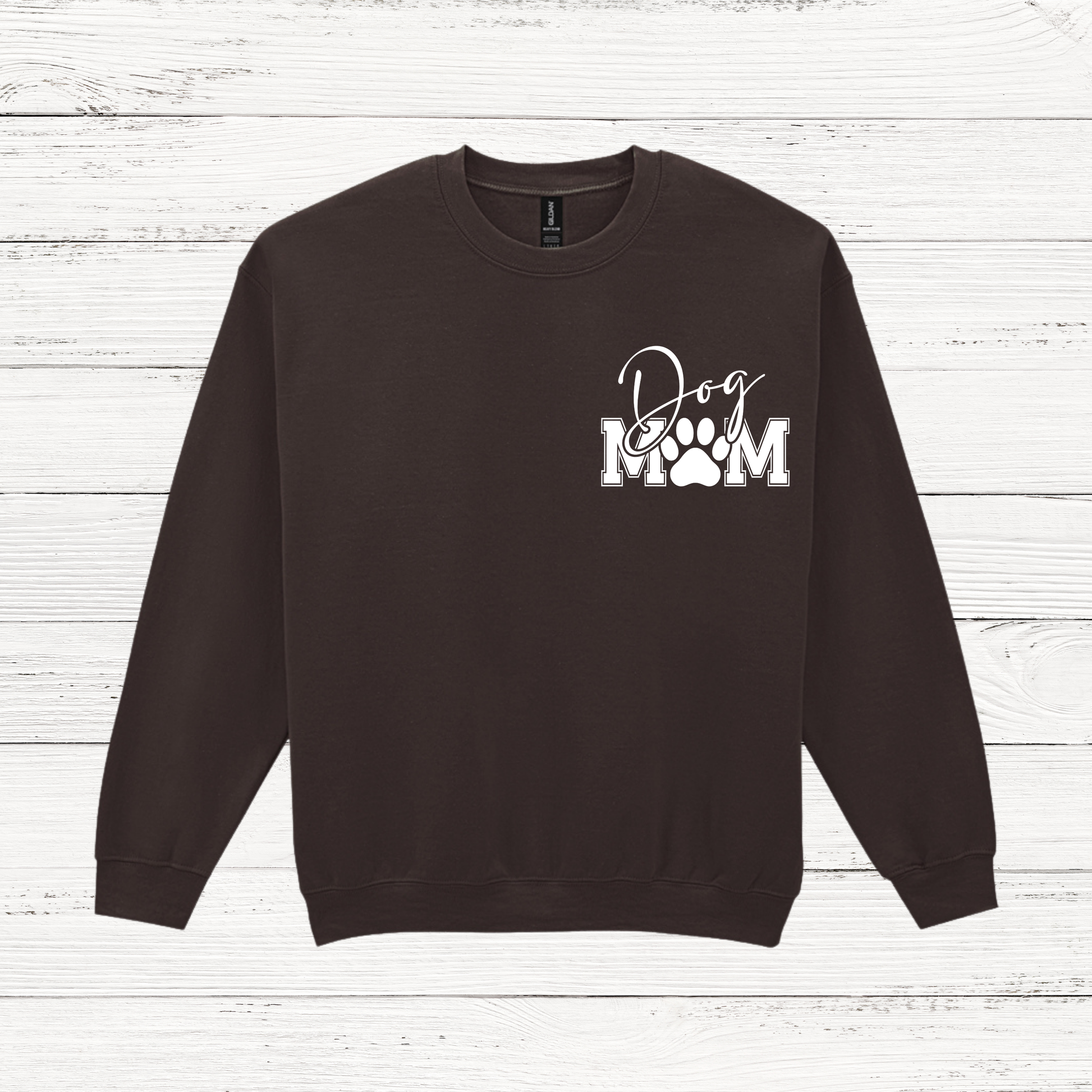 Black sweatshirt with 'Dog Mom' text on a wooden surface