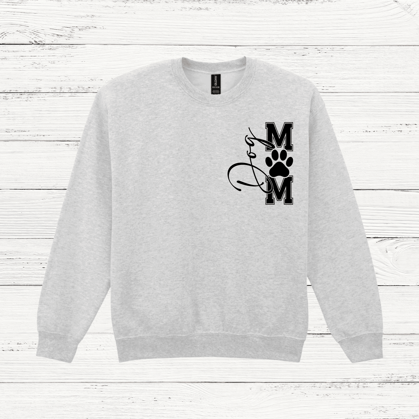Gray sweatshirt with a black graphic design on a white wooden background