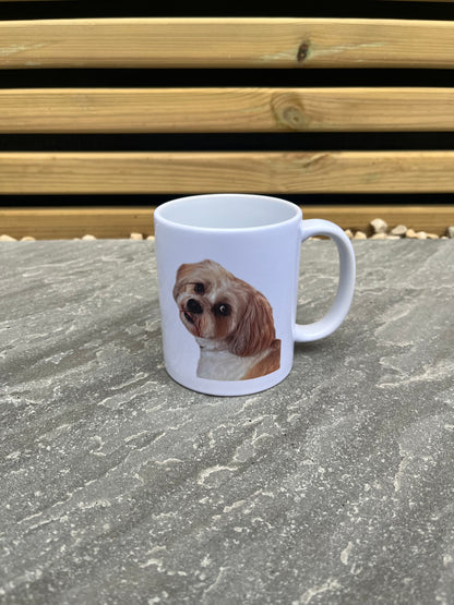 White mug with a dog's face printed on it attached to a wall.