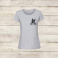 Gray t-shirt with a black dog illustration and text on a wooden surface