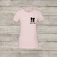 Pink t-shirt with a dog illustration and text on a wooden surface