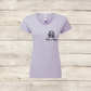 Lavender t-shirt with a dog illustration and text on a wooden surface