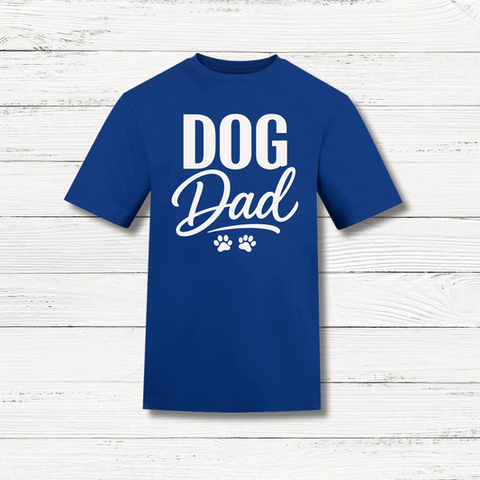 Blue t-shirt with 'DOG Dad' text on a wooden surface