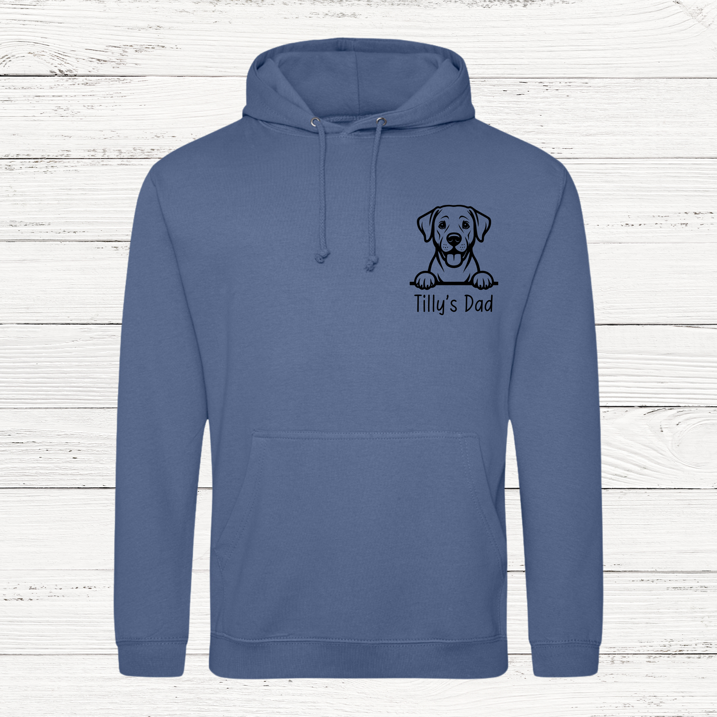 Blue hoodie with a dog illustration and text on a wooden background