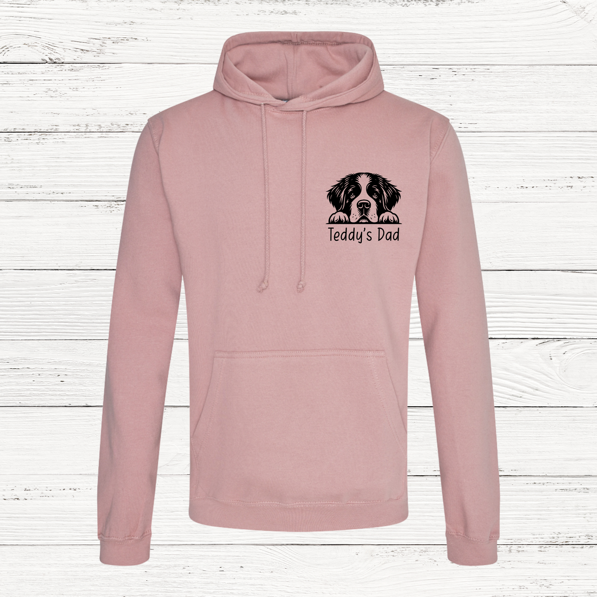 Pink hoodie with a dog illustration and text on a wooden background