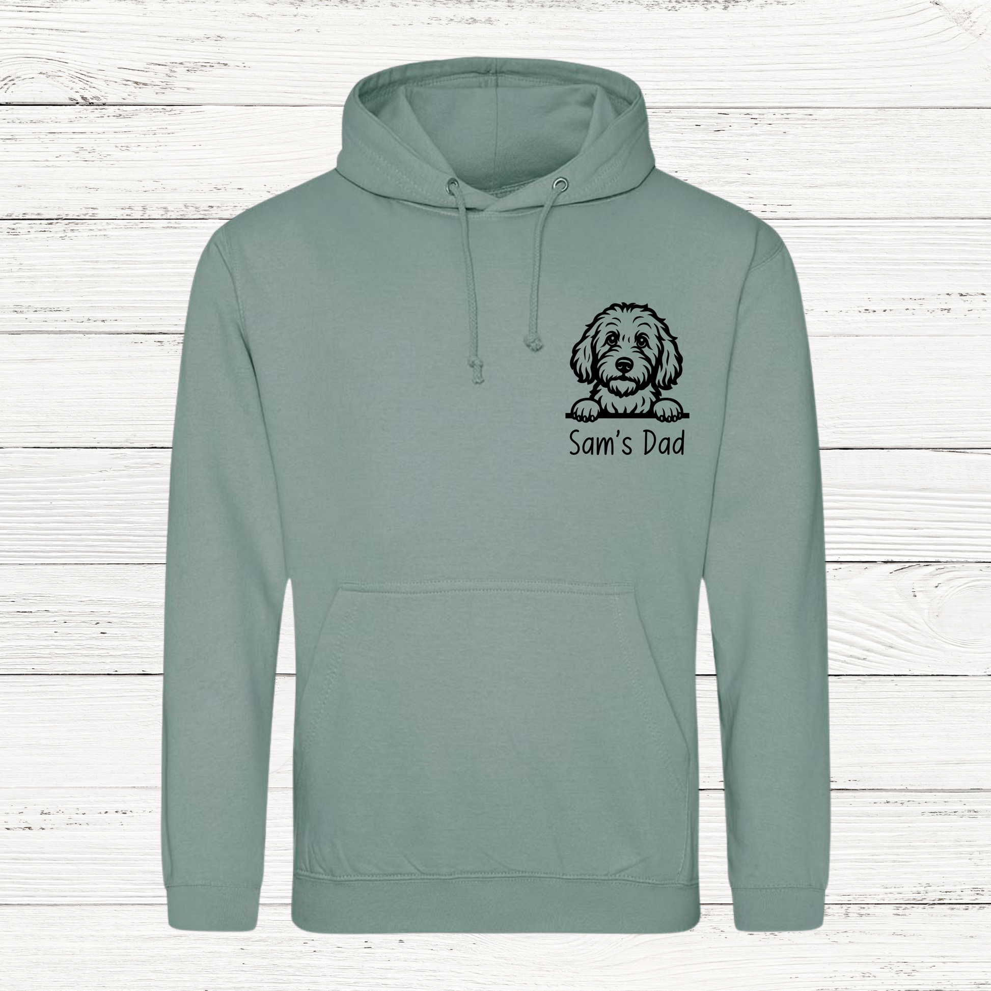 Green hoodie with a dog illustration and 'Sam's Dad' text on a wooden background