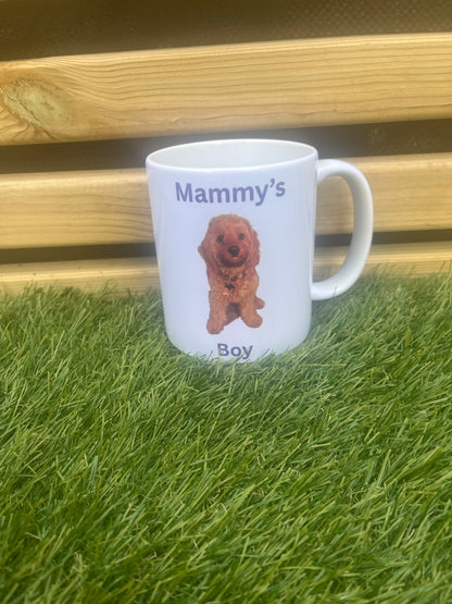 White mug with a printed design and text on grass and wooden surface
