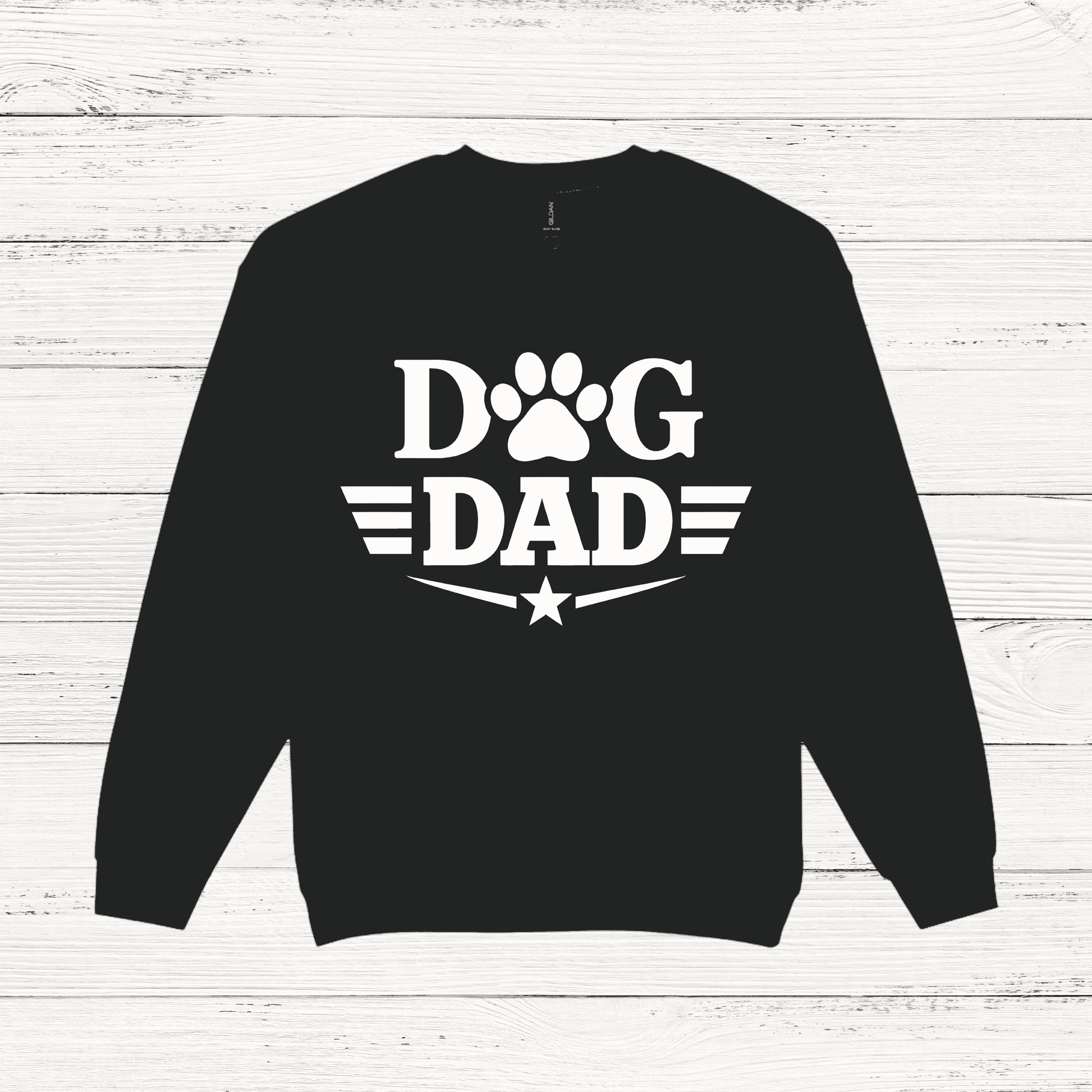 Black sweatshirt with 'Dog Dad' text on a white wooden background
