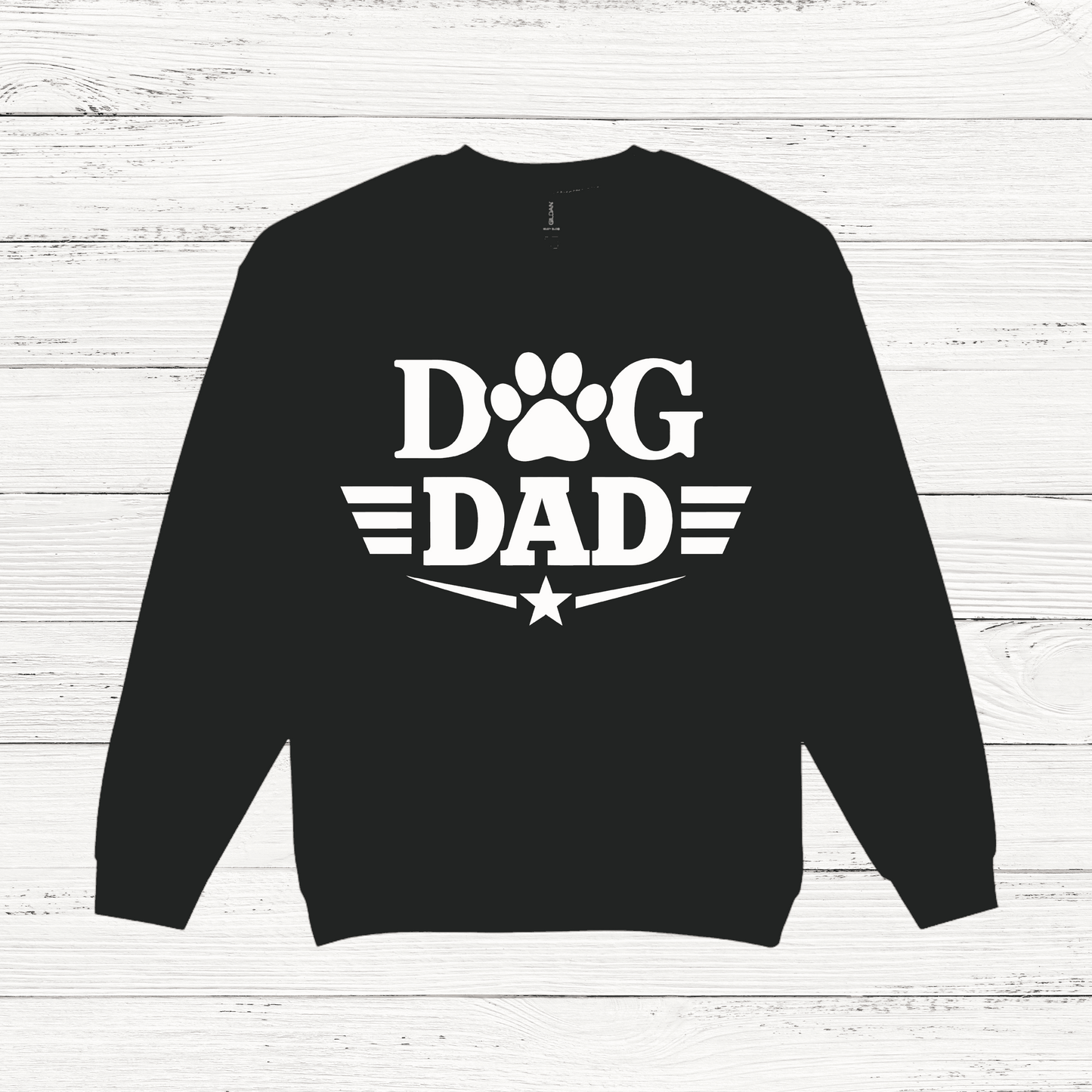 Black sweatshirt with 'Dog Dad' text on a white wooden background