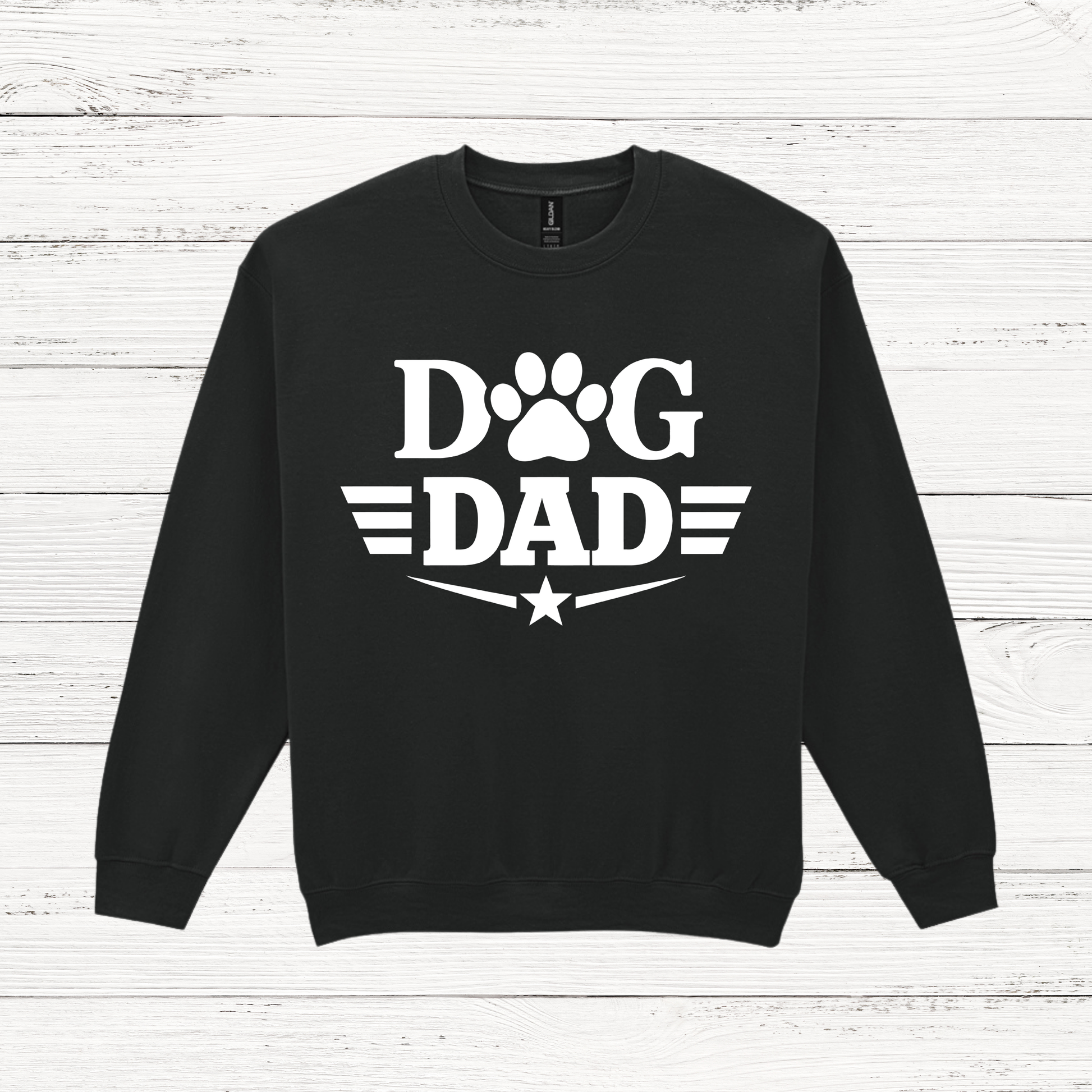 Black sweatshirt with 'Dog Dad' text on a white wooden background