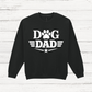 Black sweatshirt with 'Dog Dad' text on a white wooden background