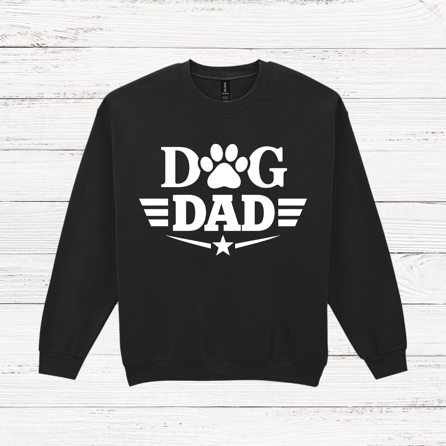 Black sweatshirt with 'Dog Dad' text on a white wooden background