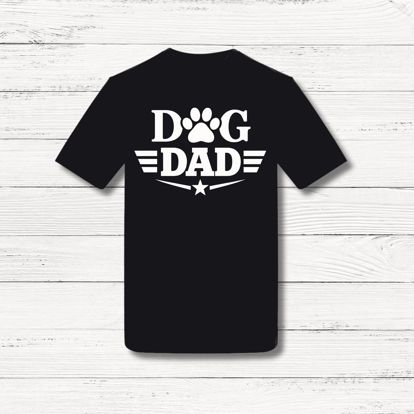Black t-shirt with 'Dog Dad' text on a white wooden background