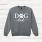 Gray sweatshirt with 'Dog Dad' text on a wooden surface