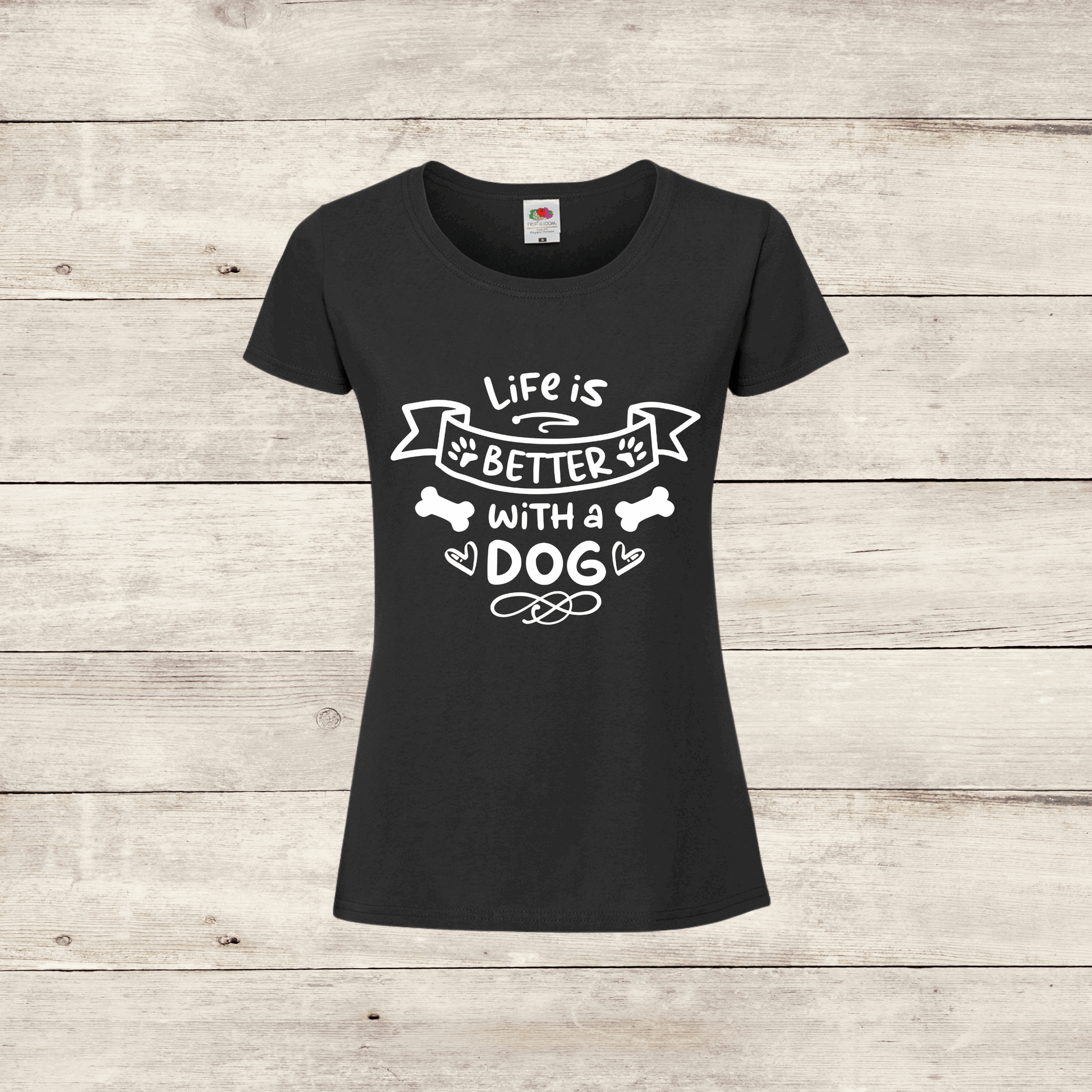 Black t-shirt with 'Life is better with a dog' text on a wooden background