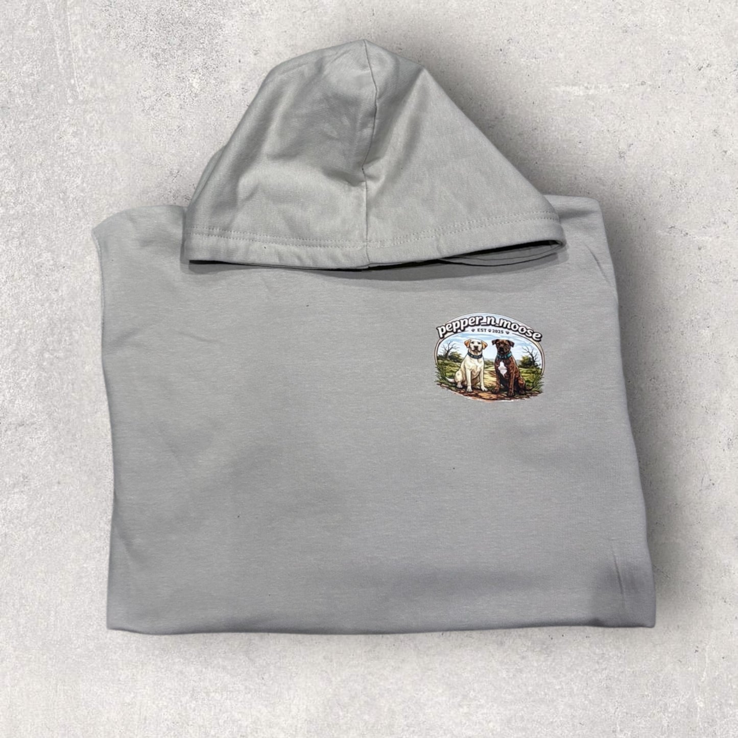 Gray hoodie with a logo on the chest against a light gray background