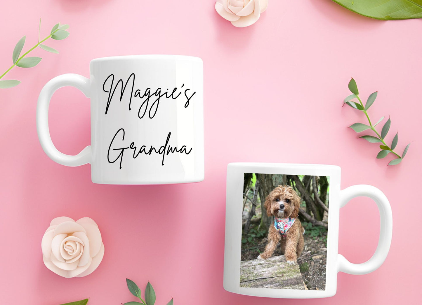 Two mugs on a pink background with one displaying 'Maggie's Grandma' text and the other featuring a dog photo.