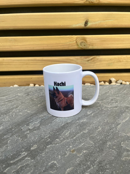 White mug with a printed design on a stone surface