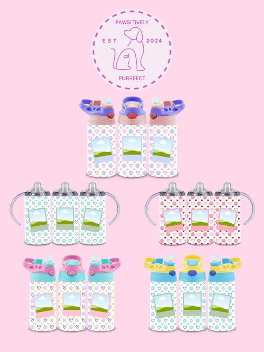Collection of children's sippy cups with polka dot pattern on a pink background, featuring a brand logo.