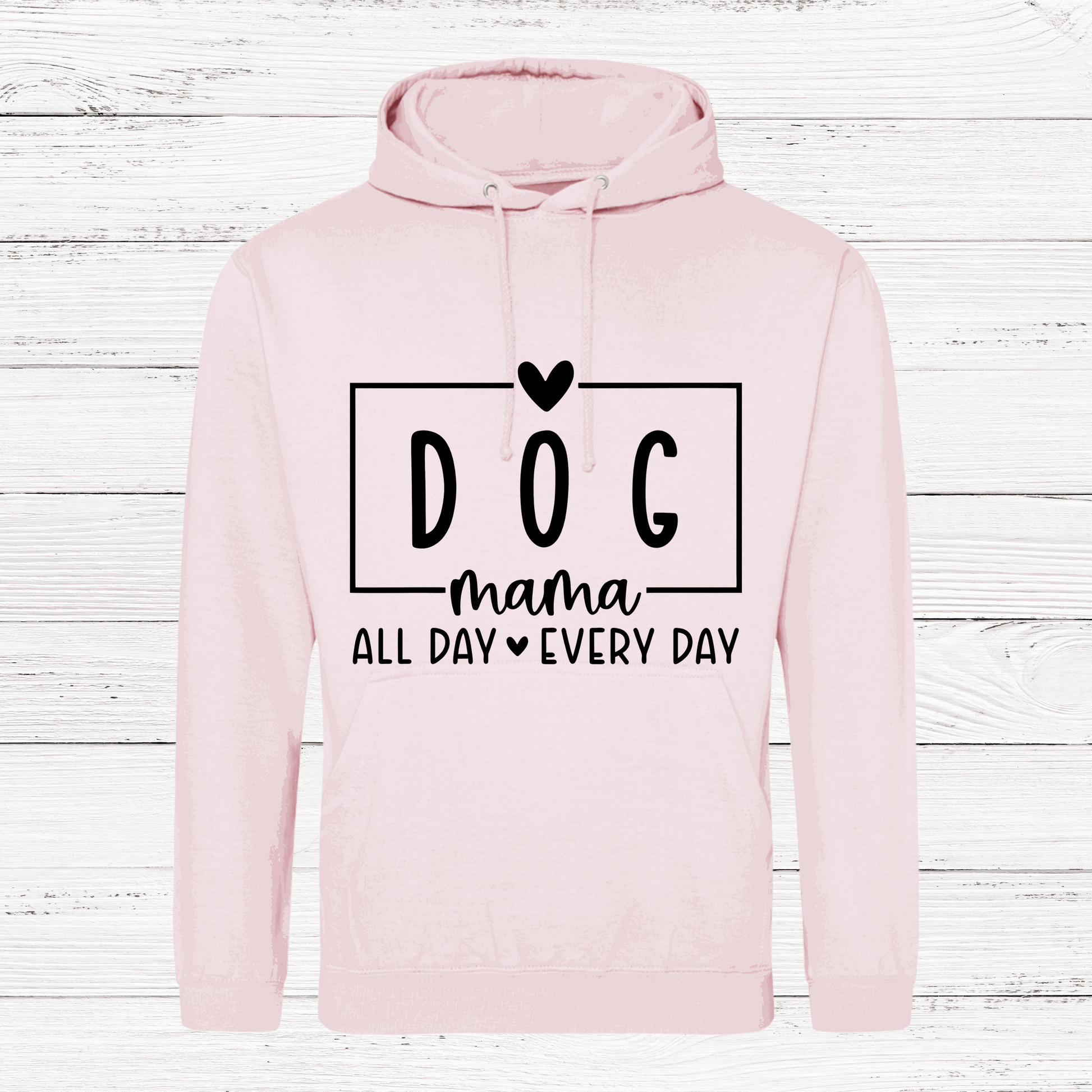Pink hoodie with 'DOG mama all day every day' text on a wooden background