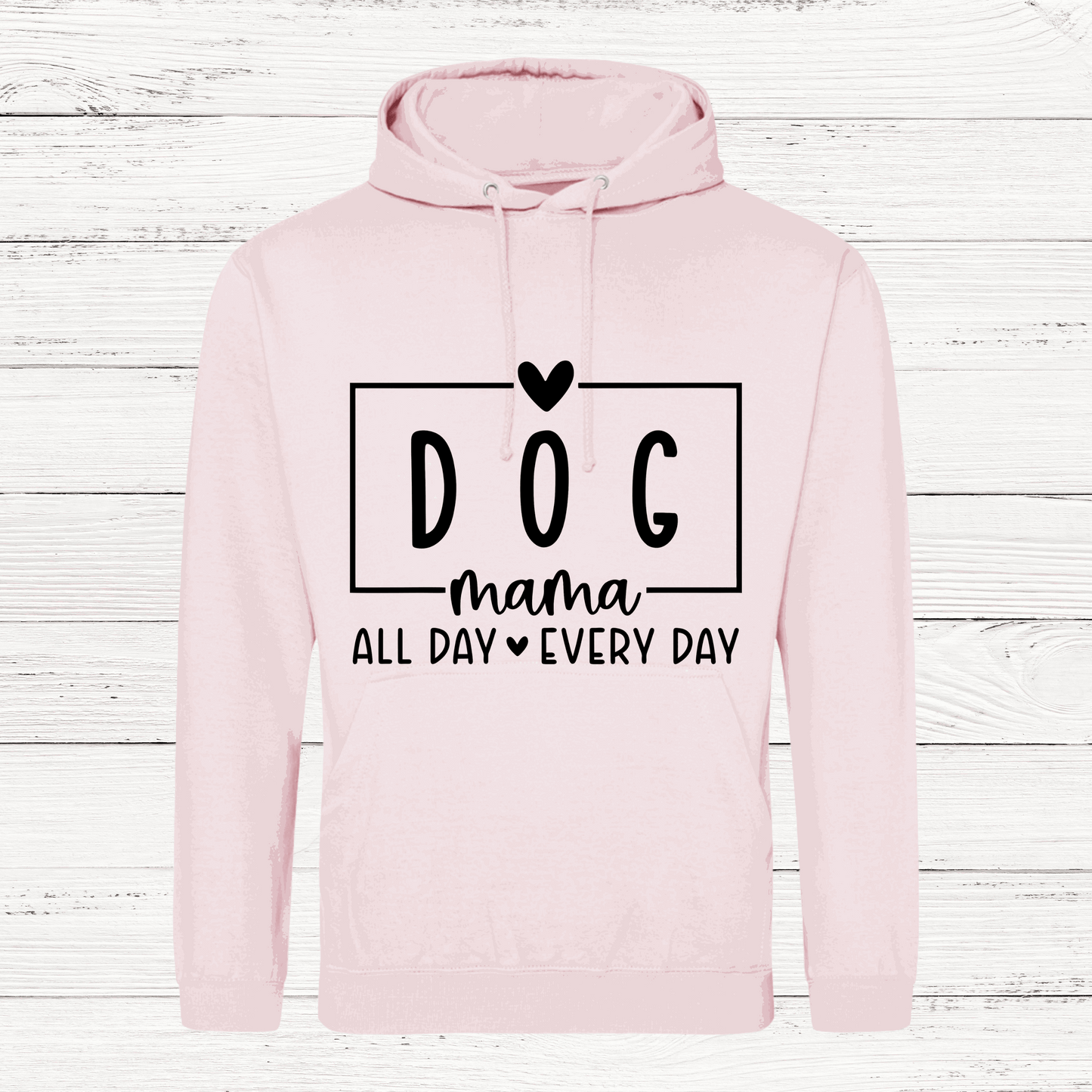Pink hoodie with 'DOG mama all day every day' text on a wooden background