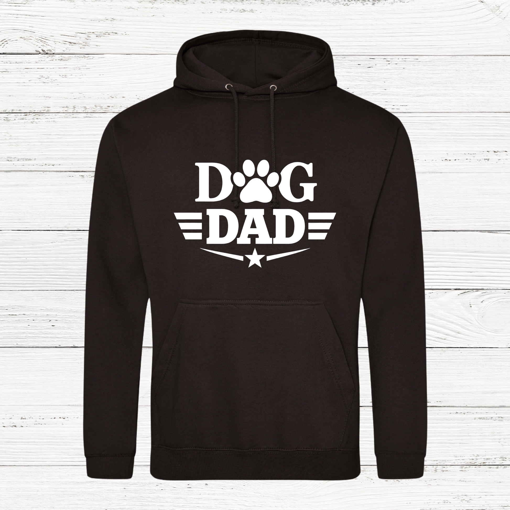 Black hoodie with 'Dog Dad' text on a white wooden background