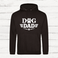 Black hoodie with 'Dog Dad' text on a white wooden background