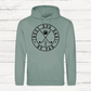 Sage green hoodie with 'Best Dog Dad by Par' text and graphics on a white wooden background