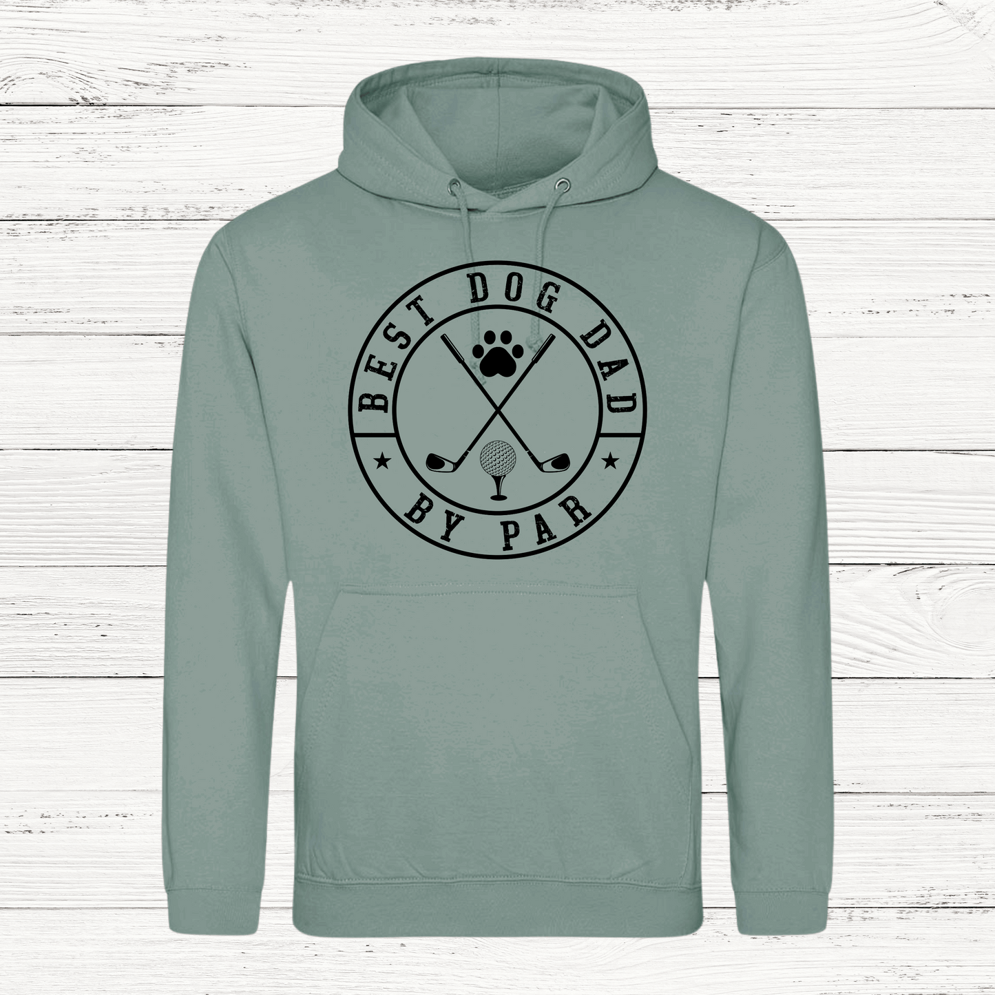 Sage green hoodie with 'Best Dog Dad by Par' text and graphics on a white wooden background