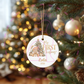 Cute teddy bear baby Christmas ornament hanging on a tree.